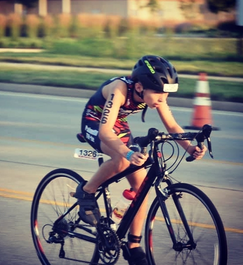 a little boy riding a bicycle in a race